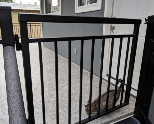 Aluminum picket gate at top of deck stairs