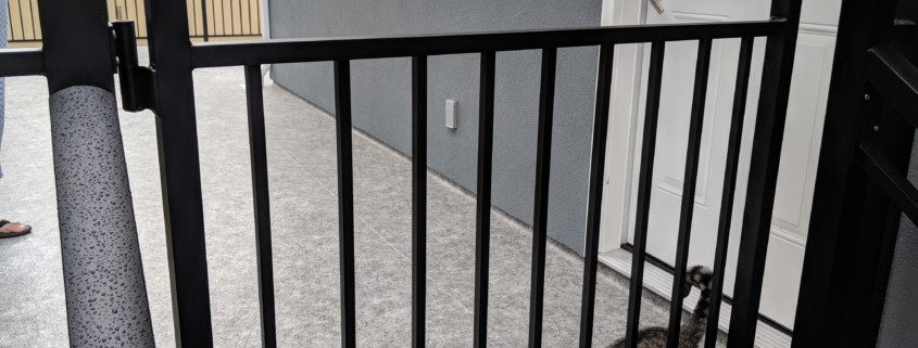 Aluminum picket gate at top of deck stairs